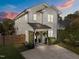 Charming two-story home showcasing modern farmhouse architectural details, landscaping, and a cozy covered front porch at 207 Grand Ave, Raleigh, NC 27606