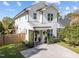 Charming two-story home featuring a front porch with natural wood columns and a concrete driveway at 207 Grand Ave, Raleigh, NC 27606