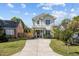 Charming two-story home with a long driveway and a well-manicured lawn at 207 Grand Ave, Raleigh, NC 27606