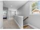 This hallway features neutral carpet with a view to a desk and bed at 207 Grand Ave, Raleigh, NC 27606