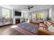 Bright and spacious living room features a fireplace, a comfortable sofa, a colorful rug, and large windows at 207 Grand Ave, Raleigh, NC 27606