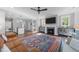Bright living room boasts a fireplace, hardwood floors, and an open concept design at 207 Grand Ave, Raleigh, NC 27606