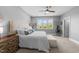 Bright main bedroom with a large window, ceiling fan, and neutral decor at 207 Grand Ave, Raleigh, NC 27606