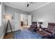 This office has hardwood floors, neutral walls, two leather chairs, and a decorative blue rug at 207 Grand Ave, Raleigh, NC 27606