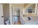 Elegant bathroom with dual sink vanity, illuminated mirror, and modern fixtures at 210 Holloway Rd, Roxboro, NC 27573