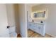 Modern bathroom with dual vanity, illuminated mirror and sleek white cabinetry at 210 Holloway Rd, Roxboro, NC 27573