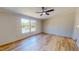 Bright bedroom featuring light wood flooring, neutral walls, and two large windows at 210 Holloway Rd, Roxboro, NC 27573