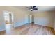 Large bedroom with light wood flooring, neutral paint, and a ceiling fan with an ensuite at 210 Holloway Rd, Roxboro, NC 27573