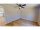 Cozy bedroom with hardwood floors and a ceiling fan at 210 Holloway Rd, Roxboro, NC 27573