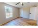 Bedroom featuring hardwood floors, a large window, and a ceiling fan at 210 Holloway Rd, Roxboro, NC 27573