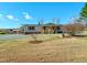 Charming home with a well-manicured front yard, red shutters, and covered porch at 210 Holloway Rd, Roxboro, NC 27573