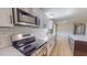 Modern kitchen with stainless steel appliances, white subway tile backsplash, and white cabinetry at 210 Holloway Rd, Roxboro, NC 27573