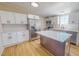 Modern kitchen with stainless steel appliances, island, white cabinets, and subway tile backsplash at 210 Holloway Rd, Roxboro, NC 27573