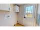 Laundry area with cabinets and backdoor with porch access at 210 Holloway Rd, Roxboro, NC 27573
