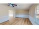 Spacious living room featuring hardwood floors, neutral colors, and a ceiling fan at 210 Holloway Rd, Roxboro, NC 27573