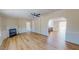 Bright living room with a cozy fireplace and modern wood-look flooring, connecting to the kitchen at 210 Holloway Rd, Roxboro, NC 27573