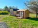 Two outdoor storage sheds on a well-maintained lawn offer practical storage solutions at 210 Holloway Rd, Roxboro, NC 27573