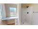 Clean bathroom featuring walk-in shower and built-in vanity with natural light at 210 Holloway Rd, Roxboro, NC 27573