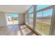 Bright sunroom featuring a wall of windows and sliding glass doors leading to the outdoor deck at 210 Holloway Rd, Roxboro, NC 27573