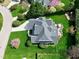 Aerial view of the home showing the well-manicured lawn, back patio, and the home's architectural roofing features at 213 Billingrath Turn Ln, Cary, NC 27519