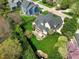 Aerial view of the backyard showing the patio, lawn, and the house's rear elevation relative to neighboring homes and street at 213 Billingrath Turn Ln, Cary, NC 27519