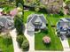 Aerial view of a well-manicured lawn surrounding a two-story home with a stone facade and a convenient three-car garage at 213 Billingrath Turn Ln, Cary, NC 27519