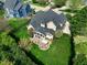 Aerial view of the backyard showing the patio, lawn, and the house's rear elevation relative to neighboring homes at 213 Billingrath Turn Ln, Cary, NC 27519