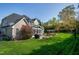 Spacious backyard with a stone patio, pergola, and lush green lawn provides a serene outdoor space at 213 Billingrath Turn Ln, Cary, NC 27519