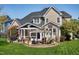 Home exterior showcasing a backyard patio with an outdoor seating area and lush landscaping, ideal for entertaining at 213 Billingrath Turn Ln, Cary, NC 27519