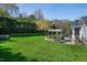 Expansive backyard with a patio, pergola, and well-maintained lawn providing a serene and private retreat at 213 Billingrath Turn Ln, Cary, NC 27519