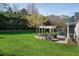 Lush backyard featuring a well-maintained lawn and patio with an outdoor seating area, perfect for relaxing and entertaining at 213 Billingrath Turn Ln, Cary, NC 27519