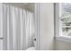 Neutral bathroom with a bright window and a view into the shower and toilet area at 213 Billingrath Turn Ln, Cary, NC 27519