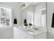 Bright bathroom featuring a double vanity, large mirror, and window with great natural light at 213 Billingrath Turn Ln, Cary, NC 27519