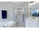 Elegant bathroom featuring a jacuzzi tub, glass-enclosed shower, and white vanity, creating a relaxing and luxurious experience at 213 Billingrath Turn Ln, Cary, NC 27519
