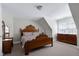 Comfortable bedroom featuring carpet flooring, neutral paint, and traditional wood furniture under a vaulted ceiling at 213 Billingrath Turn Ln, Cary, NC 27519