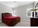 Bedroom featuring carpet, neutral paint, and traditional wood furniture with a window overlooking the backyard at 213 Billingrath Turn Ln, Cary, NC 27519