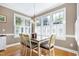 Dining area featuring bright windows, hardwood floors, and light wood furniture at 213 Billingrath Turn Ln, Cary, NC 27519