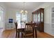 Traditional dining room with hardwood floors, wainscoting, and a dark wood dining set at 213 Billingrath Turn Ln, Cary, NC 27519
