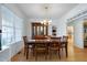 Elegant dining room featuring hardwood floors, a chandelier, and ample natural light at 213 Billingrath Turn Ln, Cary, NC 27519