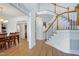 Bright, open foyer with hardwood floors, a staircase, and views into the dining area at 213 Billingrath Turn Ln, Cary, NC 27519
