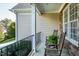 Cozy front porch featuring rocking chairs, decorative pillars, and lush greenery at 213 Billingrath Turn Ln, Cary, NC 27519