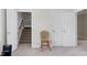 Hallway featuring carpet flooring, neutral paint, and a view of the stairs and a double-door closet at 213 Billingrath Turn Ln, Cary, NC 27519