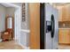 Hallway featuring stainless steel refrigerator and wood accents, blending functionality with classic design elements at 213 Billingrath Turn Ln, Cary, NC 27519