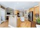 Open kitchen featuring stainless steel refrigerator and spacious central island at 213 Billingrath Turn Ln, Cary, NC 27519