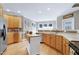 Charming kitchen features wood cabinets, stainless steel appliances, and an island for extra prep space at 213 Billingrath Turn Ln, Cary, NC 27519