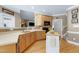 Inviting kitchen featuring wood cabinets, modern appliances, an island, and hardwood floors at 213 Billingrath Turn Ln, Cary, NC 27519
