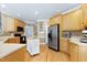 Bright kitchen features wooden cabinetry, stainless steel appliances, and hardwood flooring at 213 Billingrath Turn Ln, Cary, NC 27519