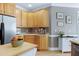 Well-lit kitchen with wood cabinets, stainless steel appliances, island, and hardwood floors at 213 Billingrath Turn Ln, Cary, NC 27519