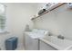 Bright laundry room features washer, dryer, sink, shelves, and a window providing natural light at 213 Billingrath Turn Ln, Cary, NC 27519