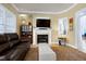 Inviting living room with a fireplace, TV, and doorway to a study at 213 Billingrath Turn Ln, Cary, NC 27519